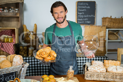 Staff holding tray of croissant at counter