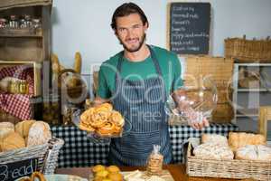 Staff holding tray of croissant at counter