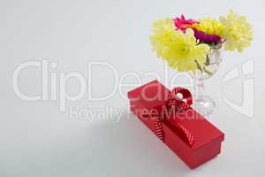 Gift box and flowers in glass