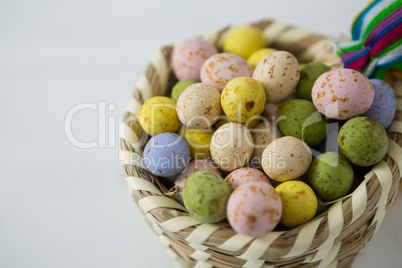 Colorful Easter eggs in wicker basket