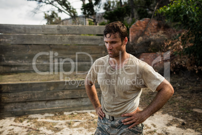 Soldier sitting on his knees with hands on his hip