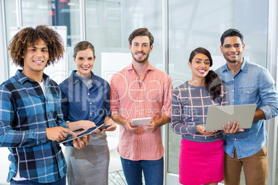 Happy executives using mobile phone, laptop and digital tablet