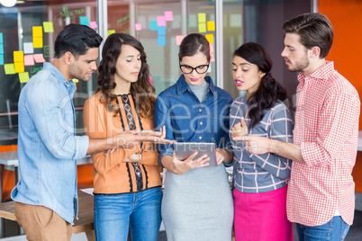 Executives having discussion over digital tablet