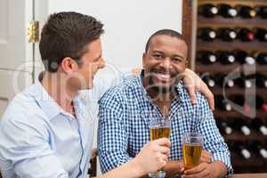 Friends laughing while having beer