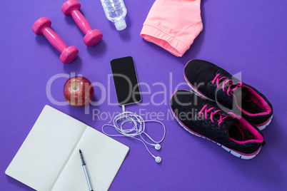 Fitness accessories with opened book, apple, mobile phone, headphones