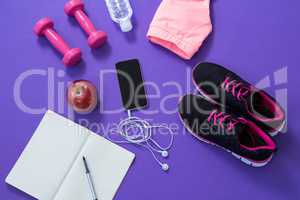 Fitness accessories with opened book, apple, mobile phone, headphones