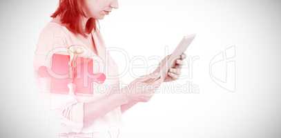 Composite image of businesswoman looking at tablet 3d