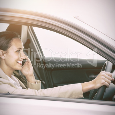 Woman driving and using her smartphone