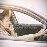 Woman driving and using her smartphone