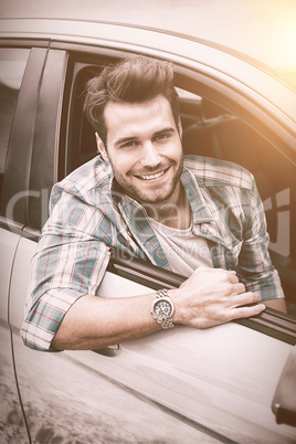 Smiling man sitting in his car