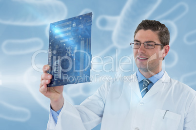 Composite image of computer engineer holding motherboard 3d