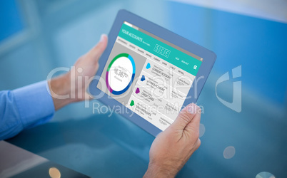 Composite image of businessman using his tablet