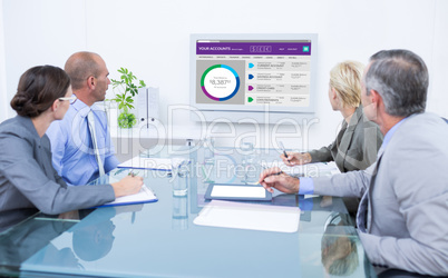 Composite image of business team looking at time clock