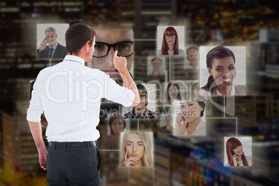 Composite image of handsome businessman pointing at a copy space