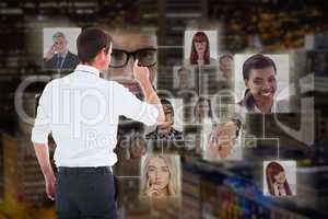 Composite image of handsome businessman pointing at a copy space