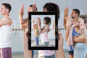 Composite image of close-up of hands holding digital tablet