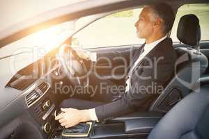 Handsome businessman in the drivers seat