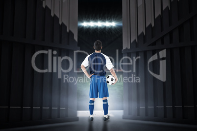 Composite image of rear view of football player holding football 3d