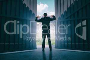 Composite image of businessman standing with hands up 3d