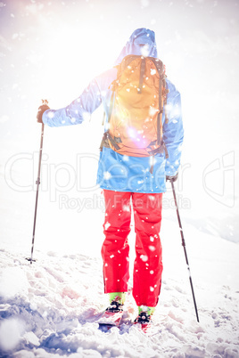 Skier walking on the slope with ski