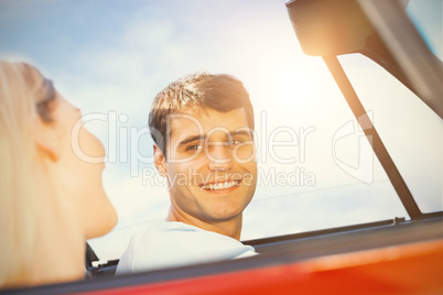 Couple in a car looking to each other