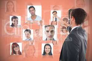 Composite image of focused businessman standing and pointing