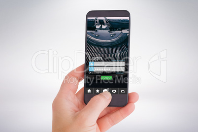 Composite image of female hand holding a smartphone