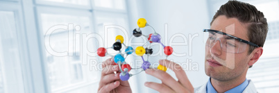 Composite image of scientist experimenting molecule structure