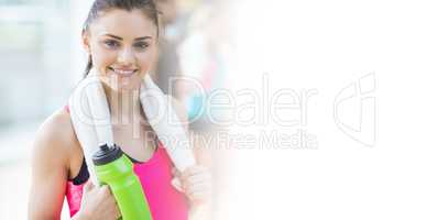 Portrait of smiling woman with towel and bottle