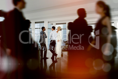 Composite image of business people walking in a blur