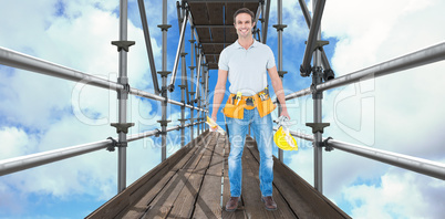 Composite image of happy repairman holding spirit level and hardhat 3d