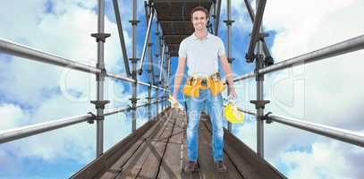 Composite image of happy repairman holding spirit level and hardhat 3d