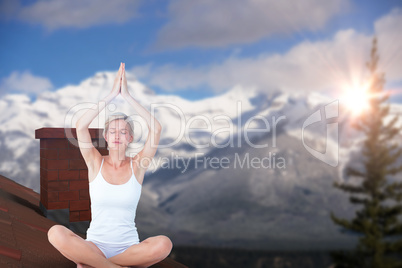 Composite image of fit woman doing yoga