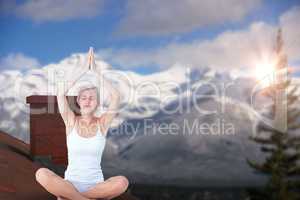 Composite image of fit woman doing yoga
