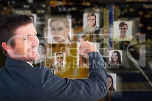 Composite image of businessman pointing with his finger