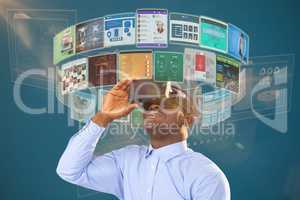 Composite image of man sitting on chair and using virtual reality headset against white background 3