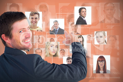 Composite image of businessman pointing with his finger