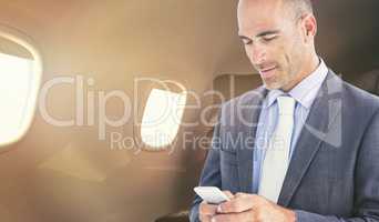 Composite image of confident businessman using cellphone