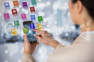 Composite image of businesswoman using mobile phone 3d