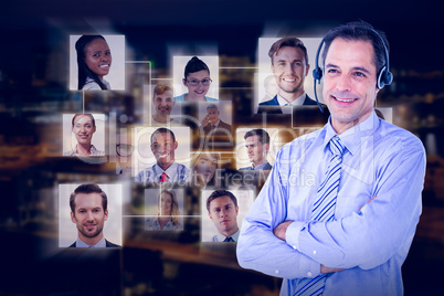 Composite image of smiling businessman using headset