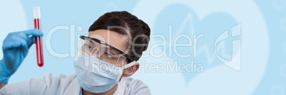 Composite image of female scientist holding test tube