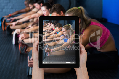 Composite image of close-up of hands holding digital tablet