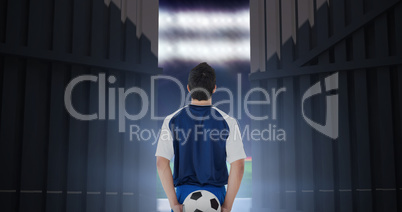 Composite image of rear view of football player holding the ball at back 3d