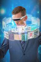 Composite image of businessman imagining while using virtual reality glasses 3d