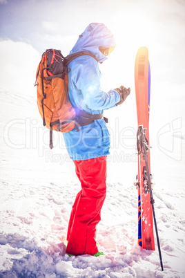Skier using mobile phone on snowy mountains