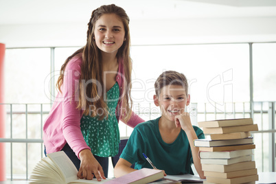 School kids doing homework in library at school