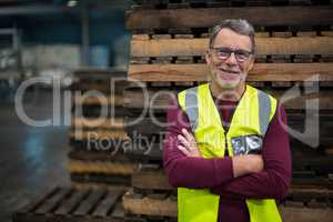 Portrait of male factory worker standing with arms crossed