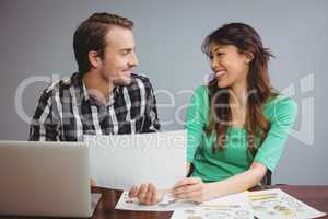 Male and graphic designers working together in conference room