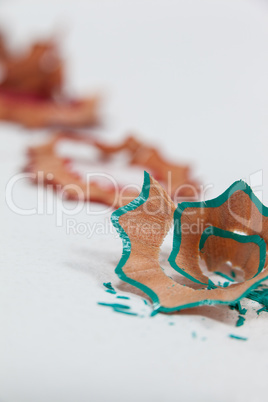 Blue colored pencil shavings on white background