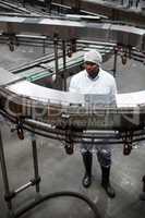 Factory engineer monitoring a production line